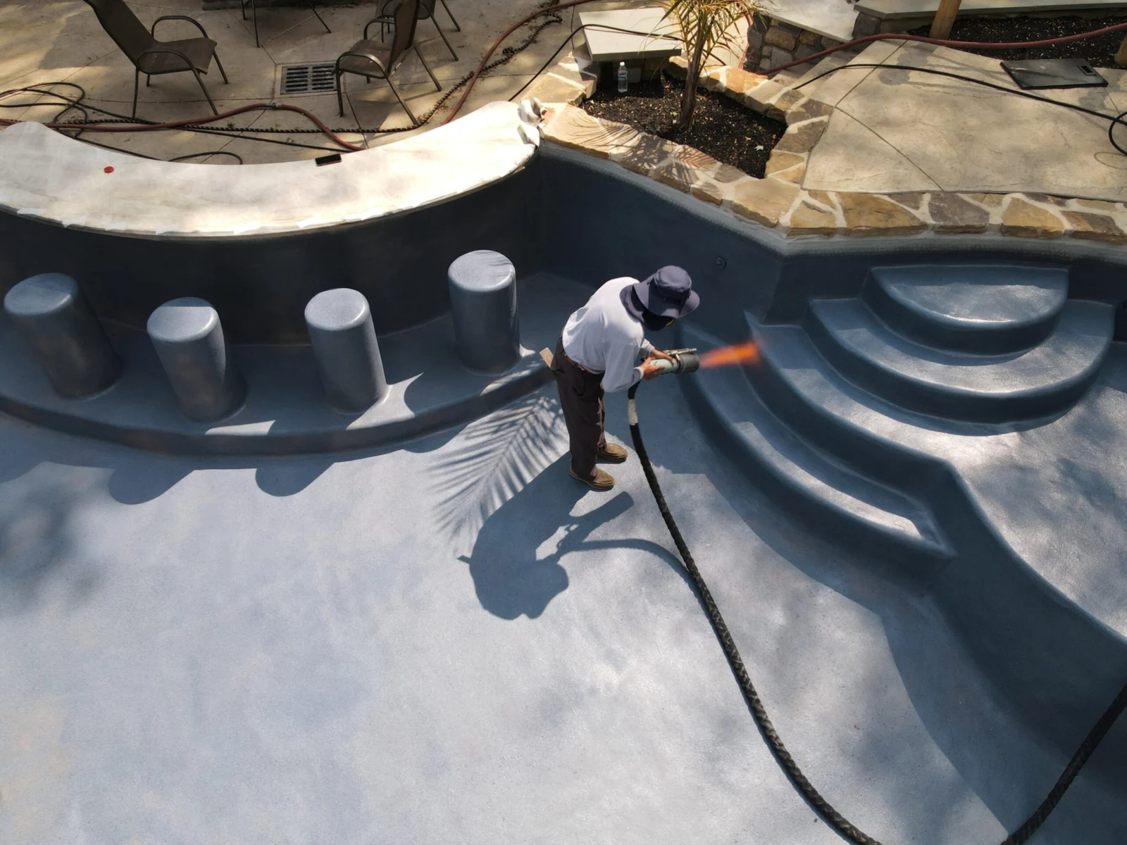 EcoFinish applicator applying aquaBRIGHT pool coating